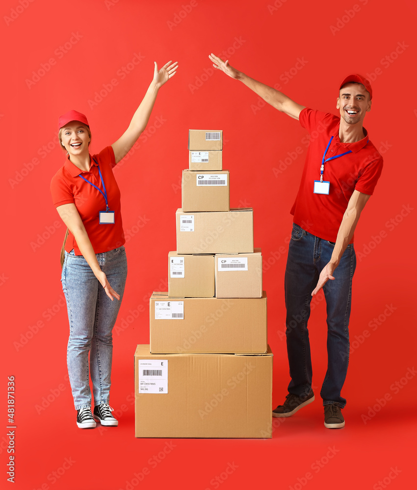 Couriers with many parcels on color background