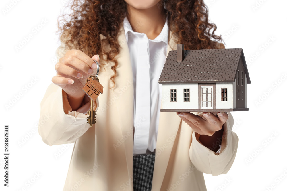 African-American real estate agent with figure of house and key on white background