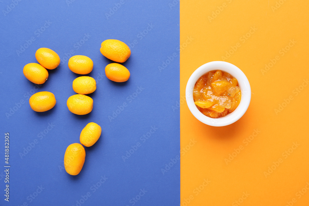 Bowl of tasty kumquat jam and fresh fruits on color background