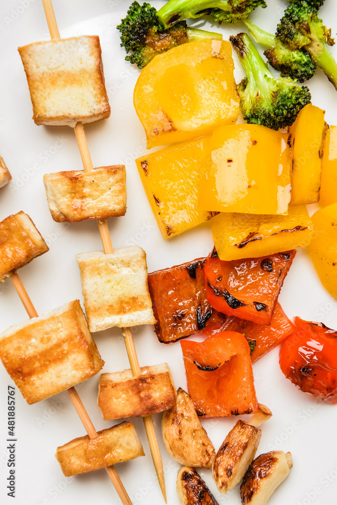 Plate with grilled tofu cheese skewers, closeup