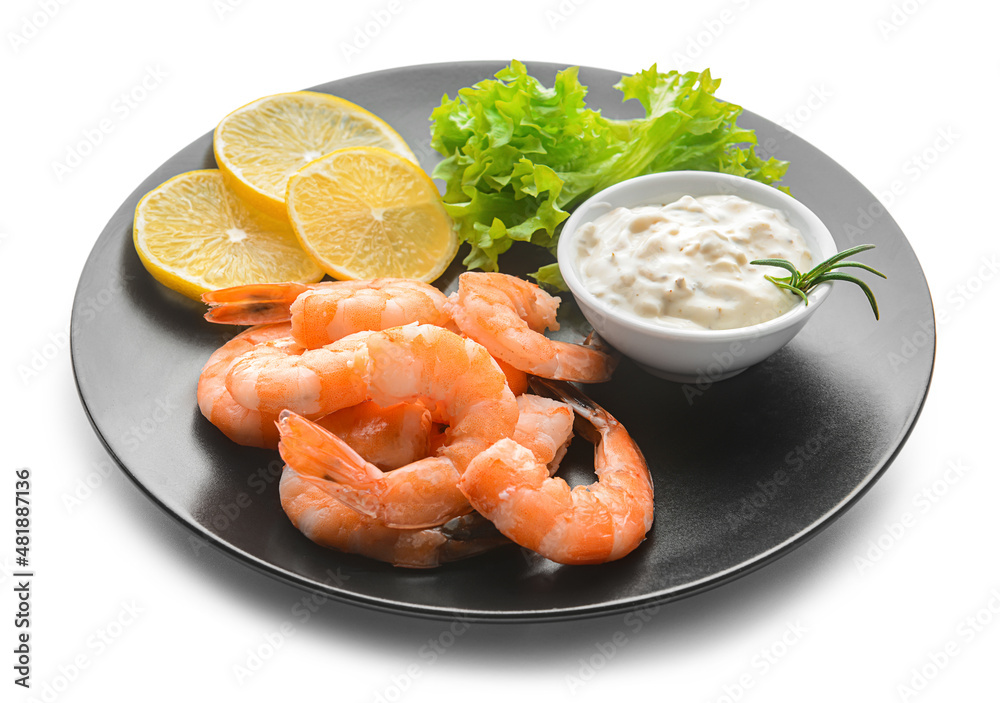 Plate of tasty boiled shrimp tails with lemon slices and sauce on white background