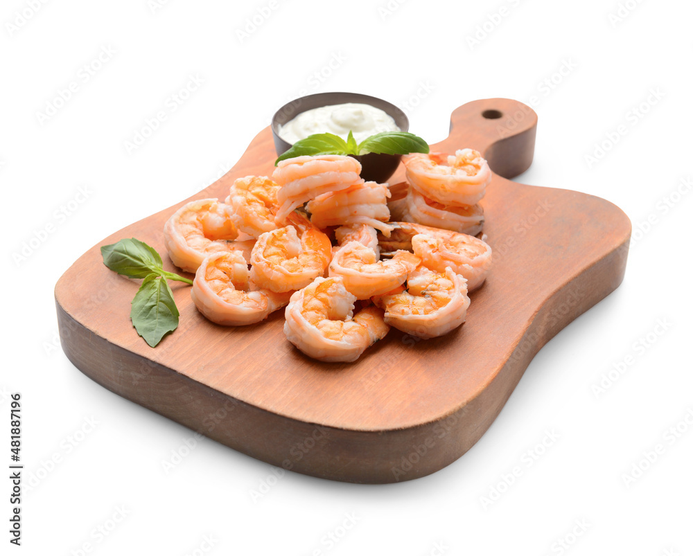 Wooden board of tasty boiled shrimp tails with sauce on white background