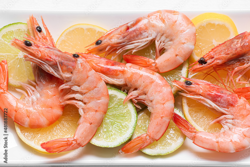 Plate of tasty shrimps with lemon on table, closeup