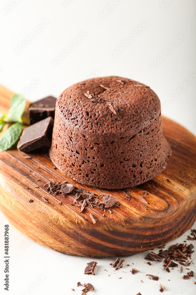 Board with tasty lava cake fondant on white background, closeup