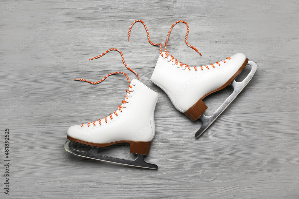 Ice skates on grey wooden background