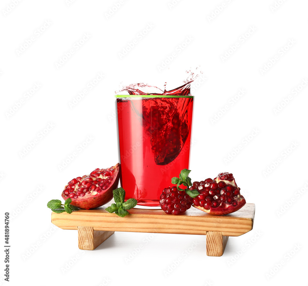 Glass of delicious pomegranate juice with splashes on white background