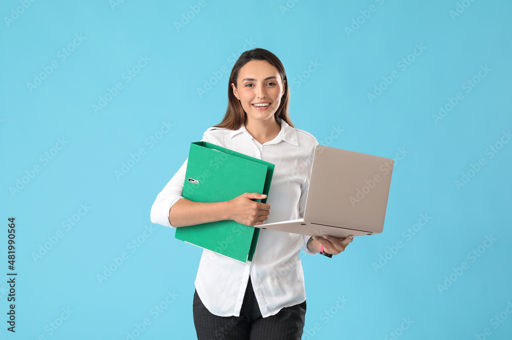 Beautiful young woman with folder and laptop on color background