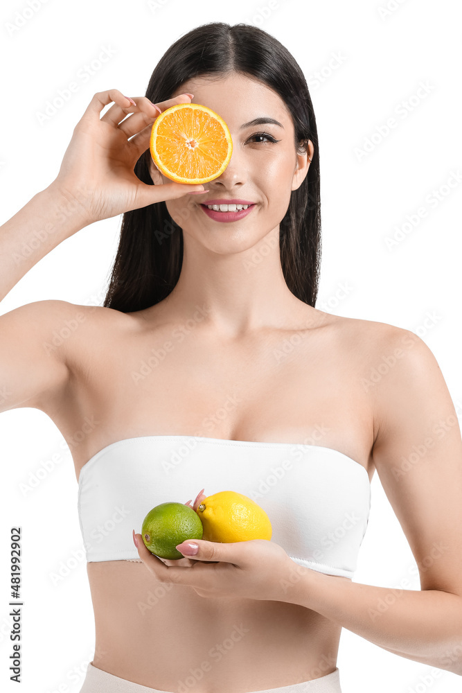 Pretty young woman with citrus fruits on white background