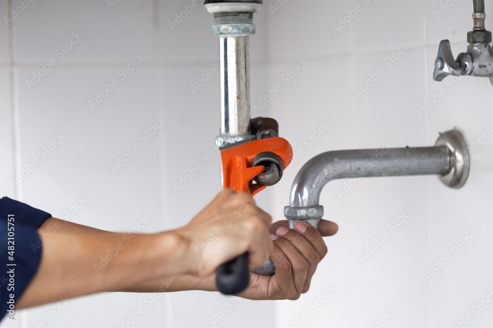 plumber at work in a bathroom, plumbing repair service, assemble and install concept.