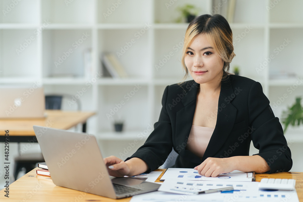 Smiling asian businesswoman professional using computer typing corporate email sit at office desk, h