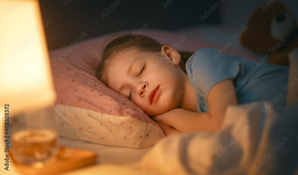 child is sleeping in the bed