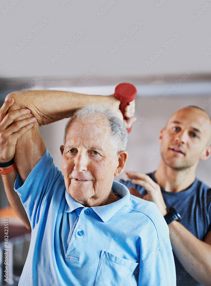 Fit for life. Shot of a senior man working out with the help of a trainer.