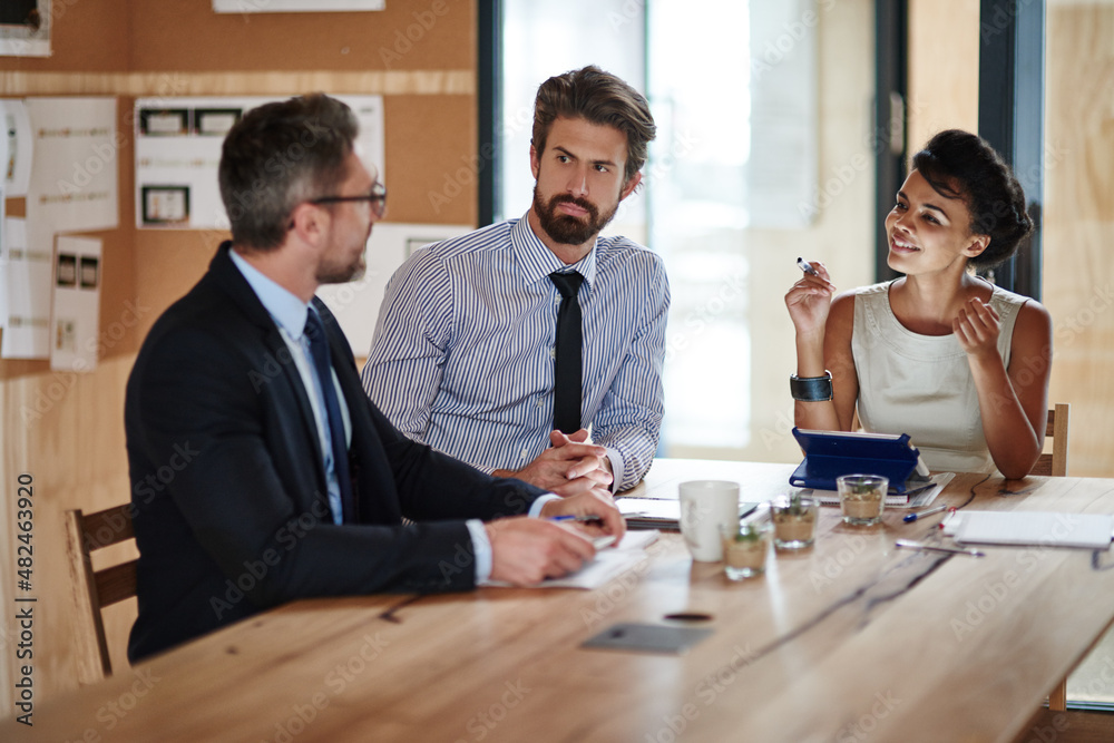 Theyre the definition of success. Shot of a group of colleagues working together in an office.