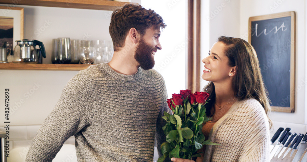 Beautiful roses for my beautiful wife. Shot of a young man surprising his wife with a bunch of roses