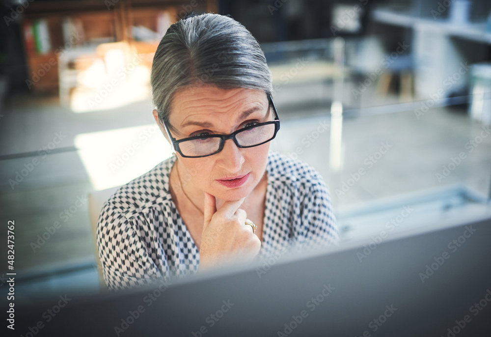 Stay focused, finish stronger. Shot of a mature businesswoman using a computer in a modern office.