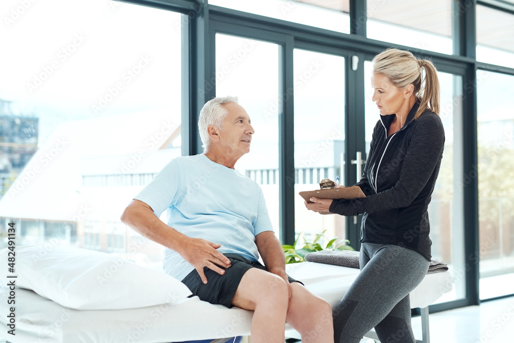 Where is the pain comping from. Shot of a senior man consulting with his physiotherapist in her offi