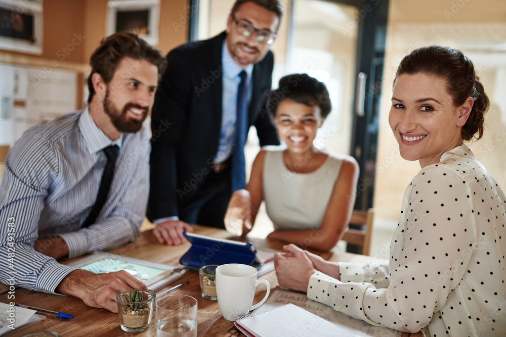 They turn ideas into successes. Portrait of a group of colleagues working together in an office.