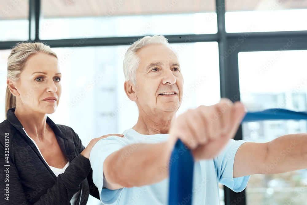 Be serious about your health. Shot of a a physiotherapist working with a senior patient using a resi