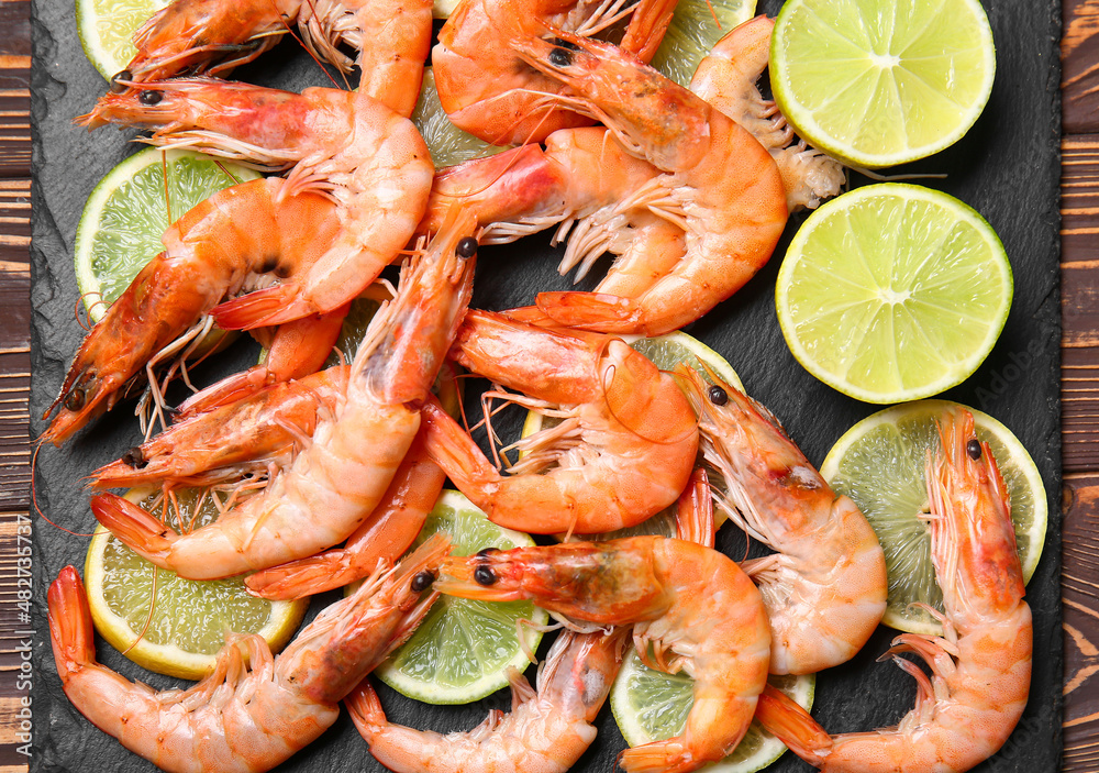 Board of tasty shrimps on table