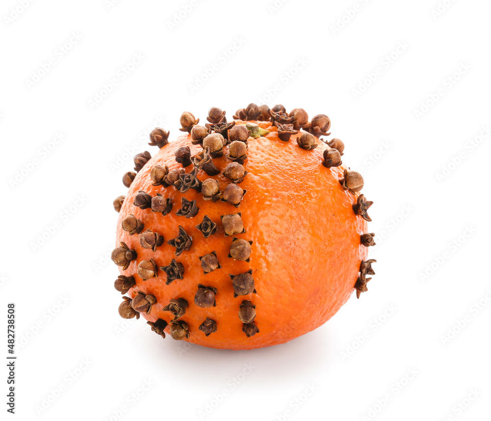 Handmade Christmas decoration made of tangerine with cloves on white background