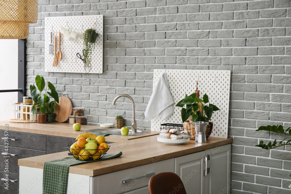 Fruit basket on table in modern kitchen interior