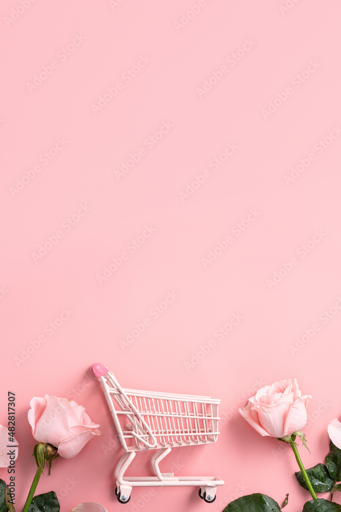 Valentines Day shopping design concept background with pink rose flower and cart on pink background