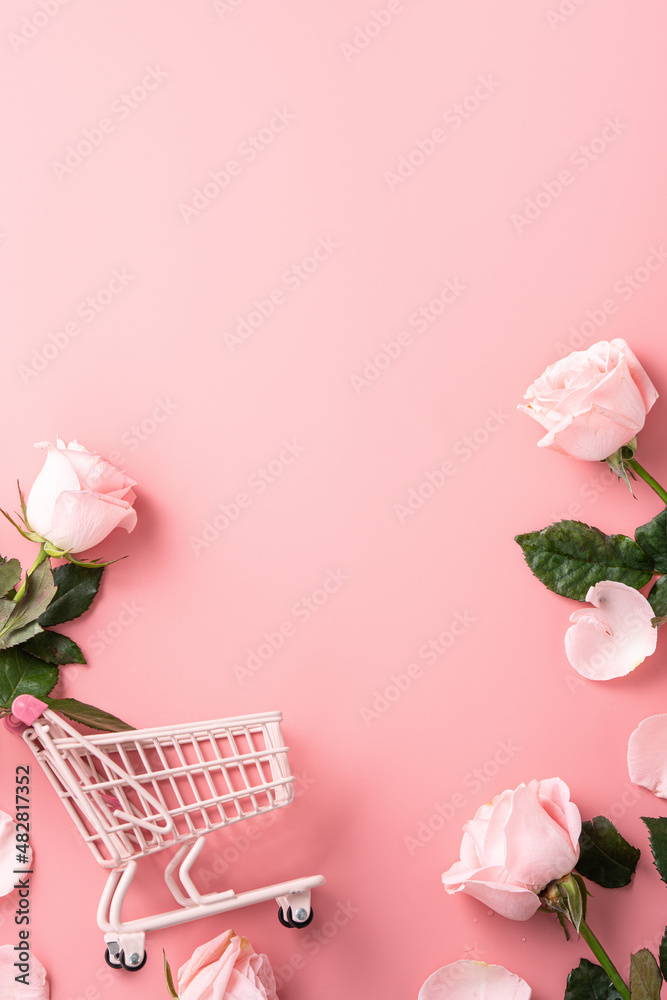 Valentines Day shopping design concept background with pink rose flower and cart on pink background