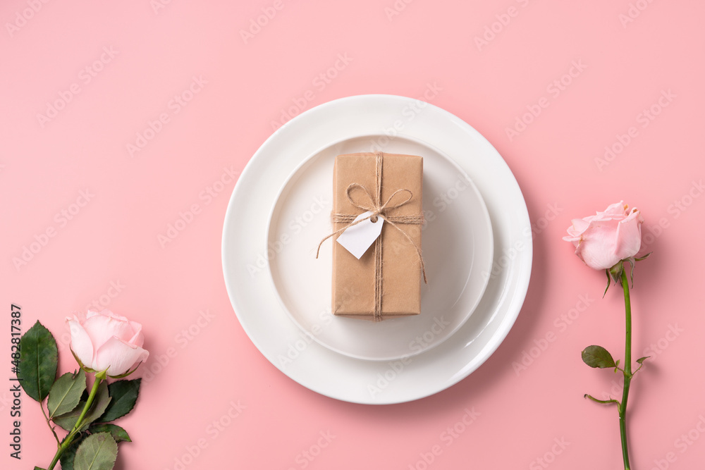 Valentines Day gift and meal design concept background with pink rose flower on pink background.