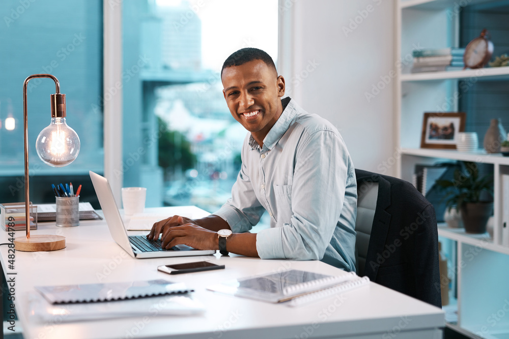 Success is a mentality. Portrait of a handsome young businessman working on his laptop during a late