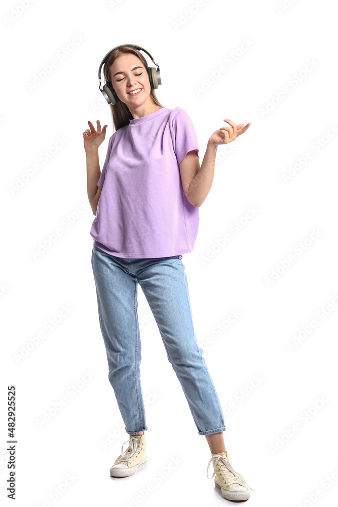 Pretty young woman in headphones listening to music on white background