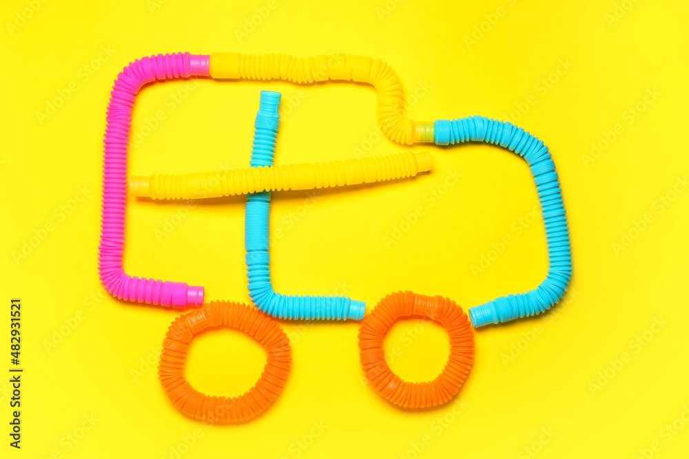 Car made of Pop Tubes on yellow background