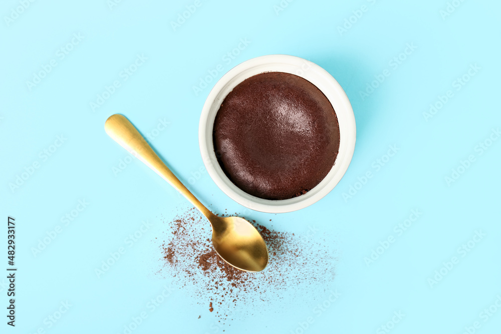 Ramekin with tasty lava cake fondant on blue background