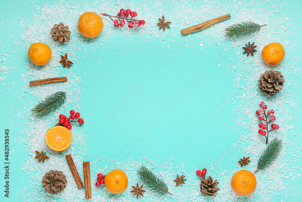 Frame made of tangerines, fir branches, spices and snow on color background