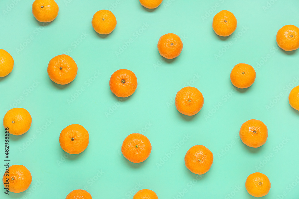 Many ripe tangerines on color background