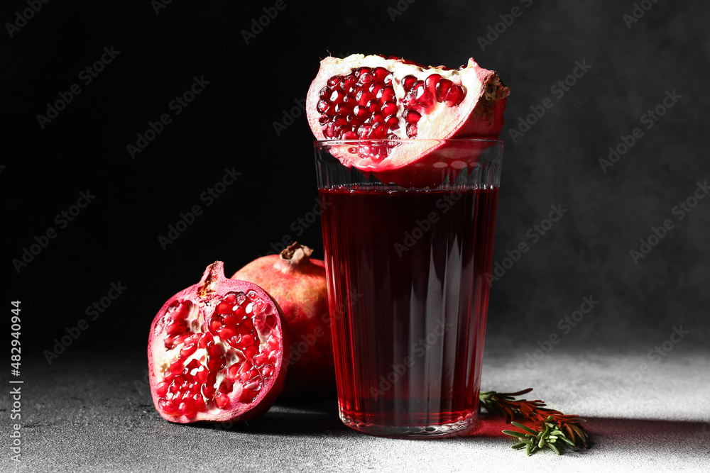 Glass of delicious pomegranate juice on table