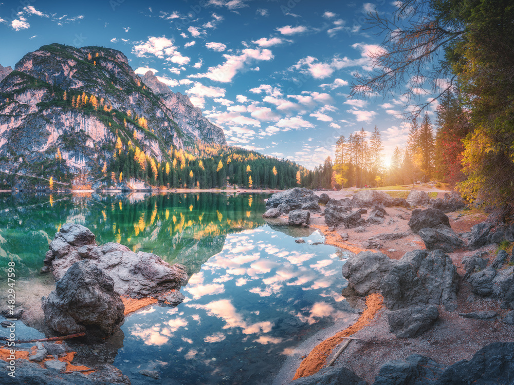 Beautiful Braies lake at sunset in autumn in Dolomites, Italy. Landscape with mountains, blue sky wi