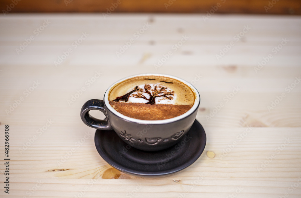 Artist draw in coffee on table with wood background and coffee beans