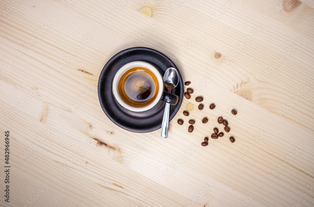 Espresso coffee from above on table with wood background and coffee beans