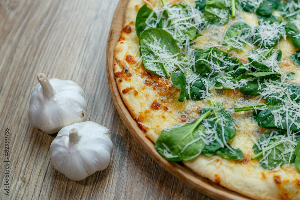 pizza with spinach and mozzarella extra shredded chessee