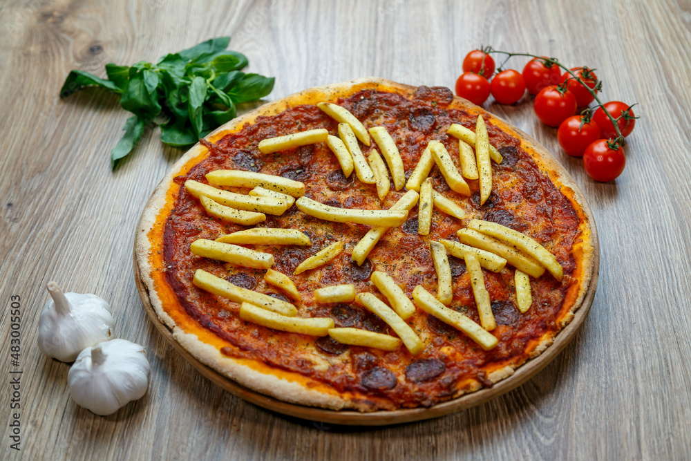 pizza with hot sausage and french fries on tomato sauce