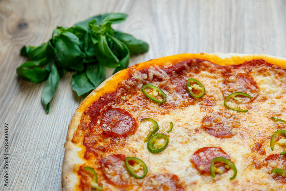 pizza with salami, mozarella, green hot pepper