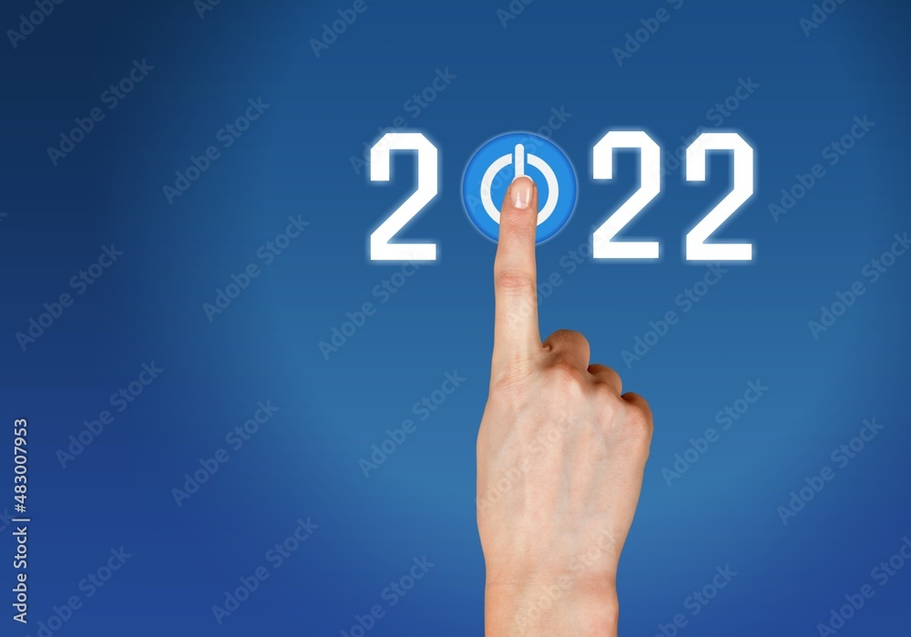 hand presses the start button for 2022. Happy New Year resolution, change, goal, vision,