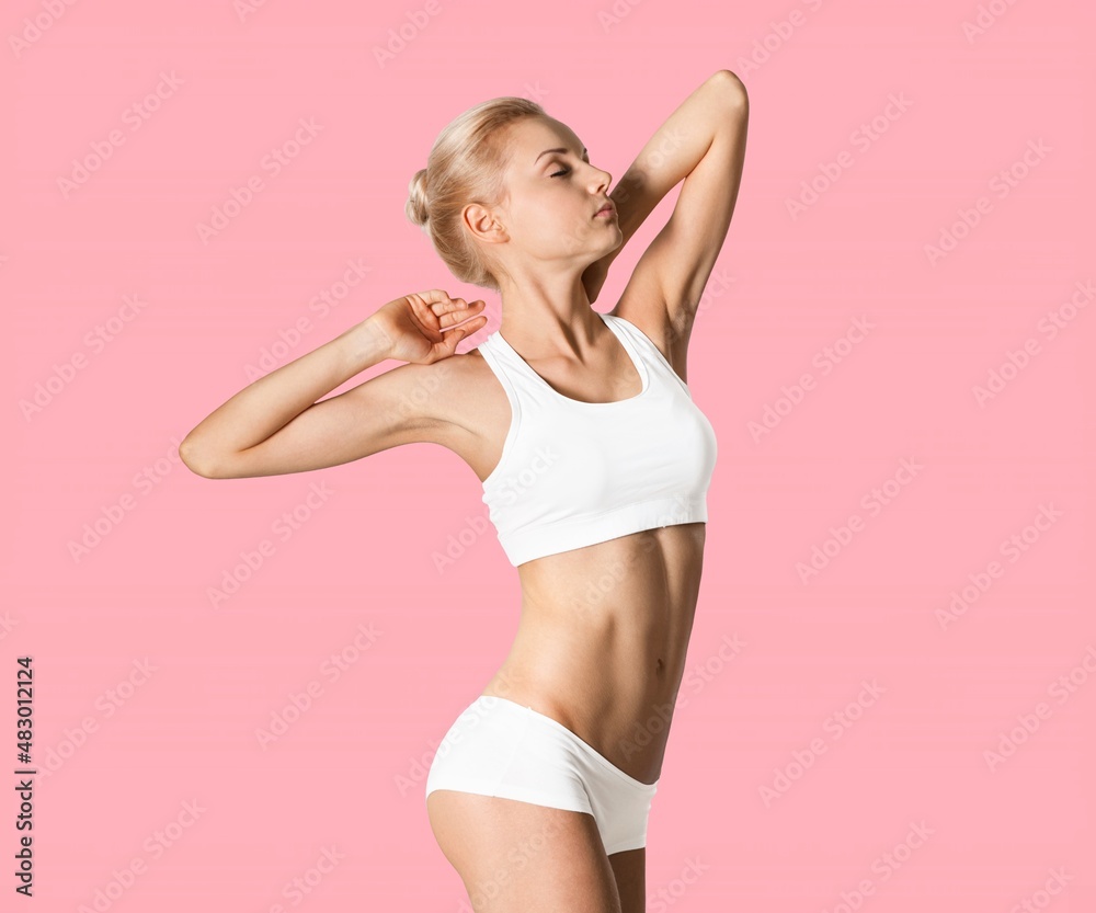 Attractive and slender girl in underwear posing in studio. Healthy lifestyle, sport and body care co