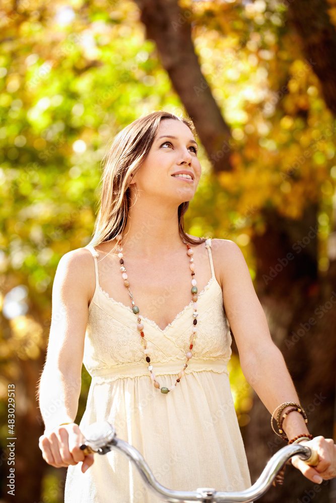 Autumn beauty. Shot of an attractive young woman in the park on an autumn day.