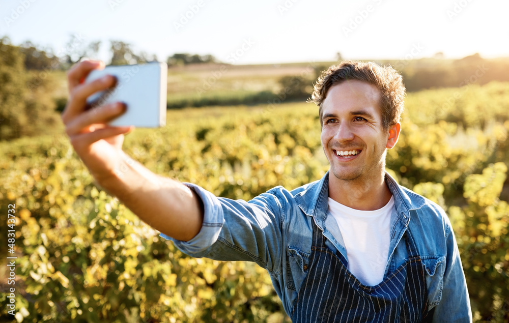 Im proud of my efforts. Shot of a young man taking a selfie with his cellphone while working on a f