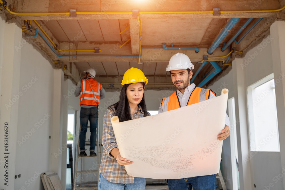 Engineers are discussing data working and blueprint with architectural project at new construction s