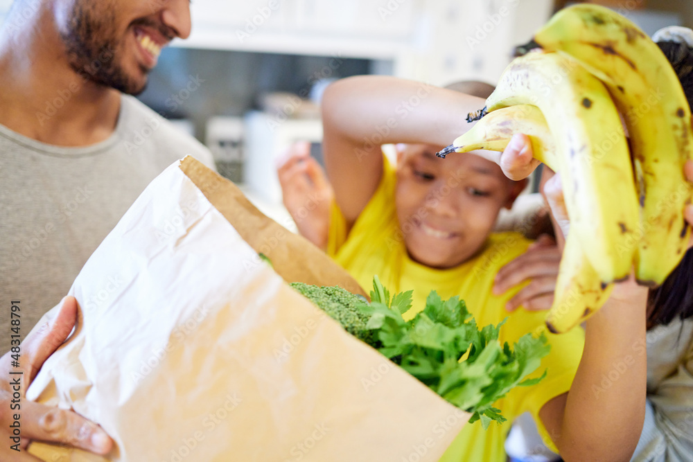 Healthy living. Shot of a family unpacking the groceries in the kitchen at home.