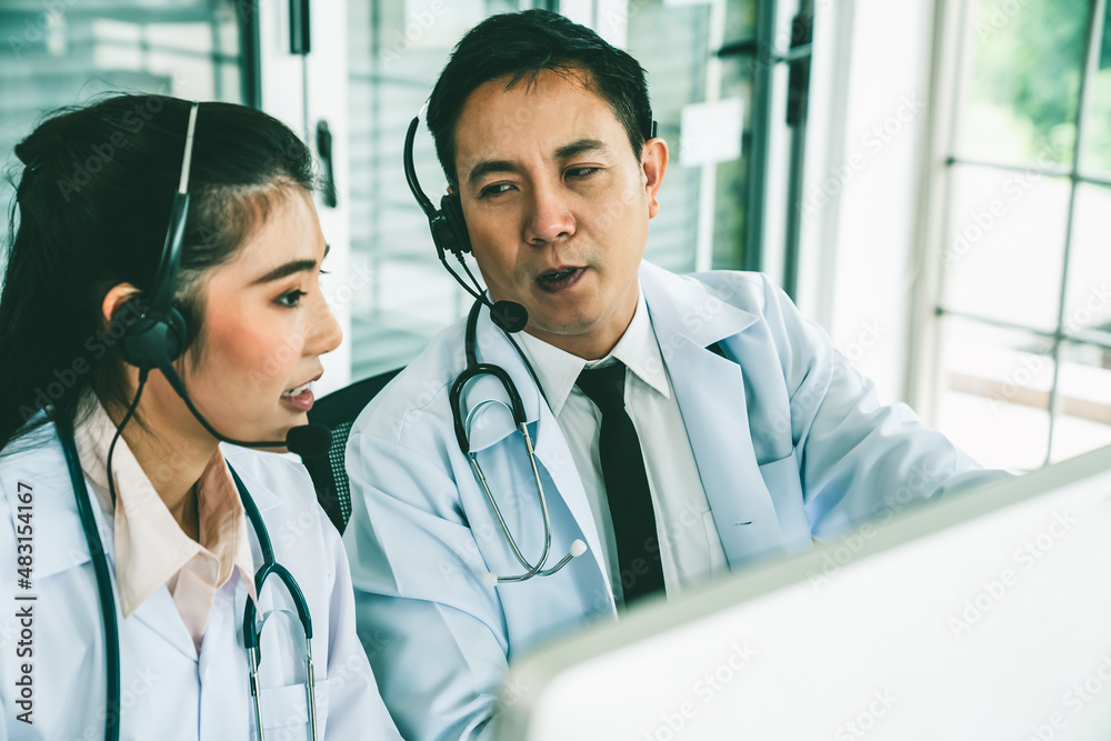 Doctor team wearing headset talking actively on video call in hospital clinic . Concept of telehealt