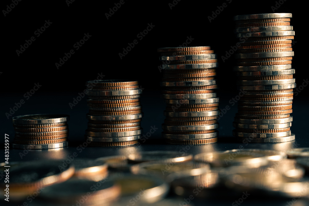 Pile of gold coins stack in finance treasury deposit bank account for saving . Concept of corporate 