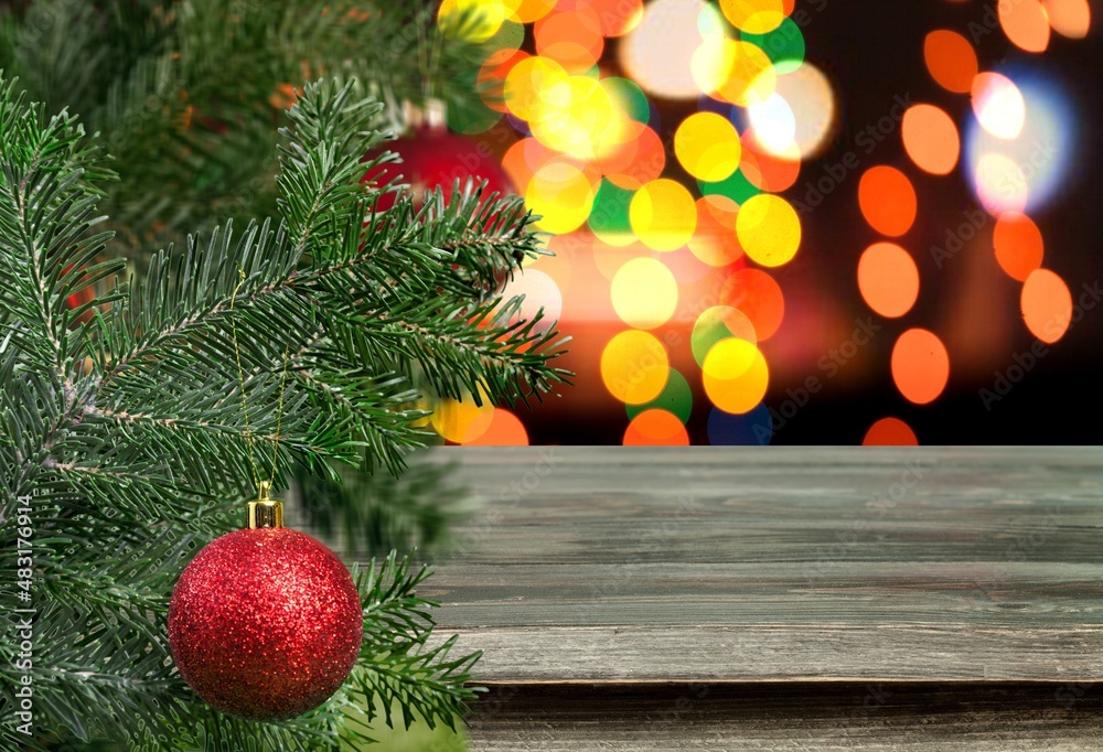 Christmas ball on the Christmas tree surrounded by festive lights.